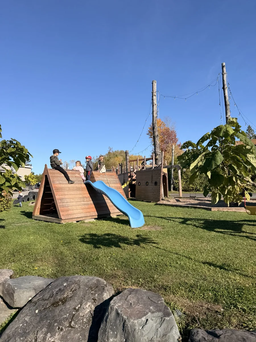 Enfants au parc en bateau de pirate, avec glissade bleue